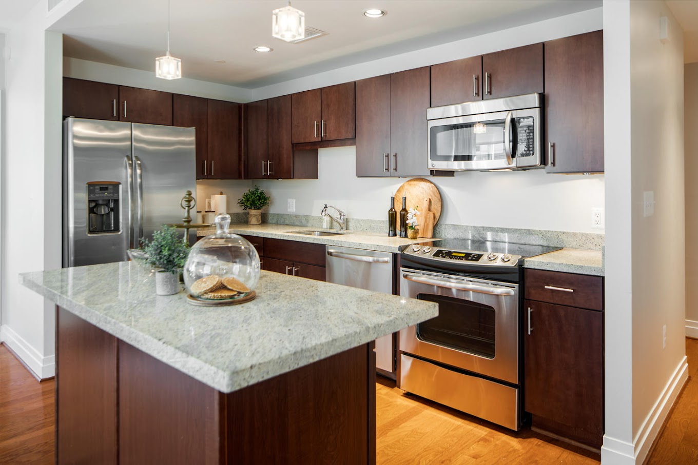 Spacious Design with Kitchen Islands, Merillat Sedona Cabinetry, GE Energy Star Stainless Steel Appliances, Kashmire White Granite Countertops