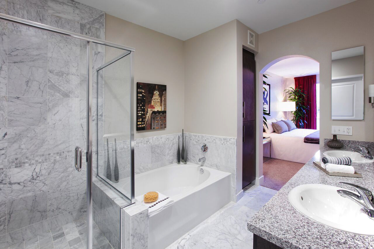 Dual bathroom vanities, soaking tub and separate stone tile shower