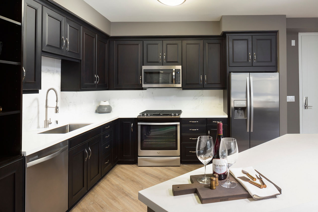 Wood plank style flooring, quartz countertops, stainless steel appliances, built in wine fridge, soft close cabinet and drawers 