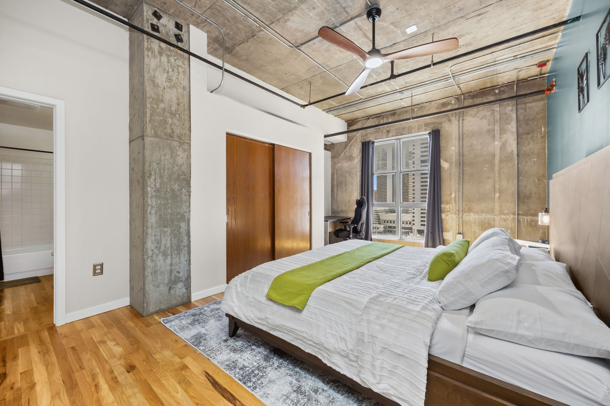 This fully furnished 1 bedroom, 1.5 bathroom condo is located in the sought-after Arapahoe SkyLofts, right in the heart of Denver. Offering 1,124 square feet of thoughtfully designed living space, this home blends modern loft-style character with comfort and convenience.
 
The condo features hardwood floors, concrete walls, and exposed ductwork, creating a clean, contemporary industrial aesthetic. The open living area flows seamlessly into the dining space, which includes seating for four, plus two bar stools at the kitchen counter, making it ideal for entertaining or casual meals.
 
The spacious primary bedroom is furnished with a king bed and provides a quiet retreat. The primary bathroom includes a tub/shower combination, while a convenient half-bath powder room is located off the main living area—perfect for guests. An in-unit washer and dryer adds everyday convenience.
 
Step out onto the private balcony and enjoy views of downtown Denver, a perfect spot for morning coffee or evening relaxation.
 
Parking is a rare downtown luxury, and this unit includes two parking spaces in the attached garage—one suitable for a compact vehicle and the other for a full-size car.
 
Built in 1983, Arapahoe SkyLofts is ideally situated near Union Station and Coors Field, with easy access to downtown office buildings, public transportation, and major roadways. The neighborhood offers an abundance of restaurants, coffee shops, and retail options, all within close proximity.
 
This fully furnished condo provides an exceptional opportunity to enjoy urban living with space, style, and convenience in one of Denver’s most vibrant locations.