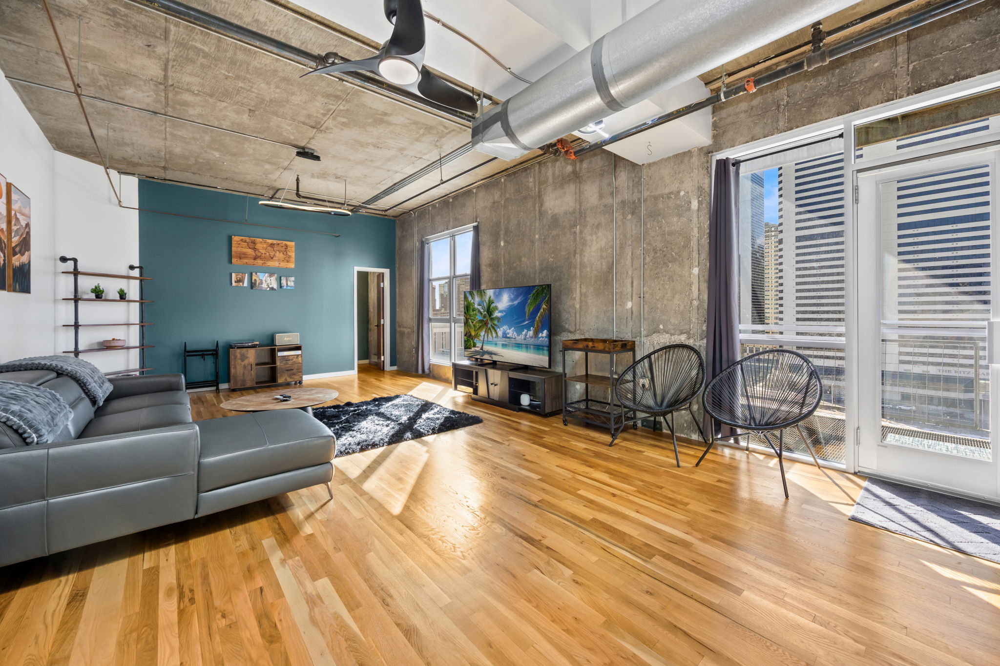 This fully furnished 1 bedroom, 1.5 bathroom condo is located in the sought-after Arapahoe SkyLofts, right in the heart of Denver. Offering 1,124 square feet of thoughtfully designed living space, this home blends modern loft-style character with comfort and convenience.
 
The condo features hardwood floors, concrete walls, and exposed ductwork, creating a clean, contemporary industrial aesthetic. The open living area flows seamlessly into the dining space, which includes seating for four, plus two bar stools at the kitchen counter, making it ideal for entertaining or casual meals.
 
The spacious primary bedroom is furnished with a king bed and provides a quiet retreat. The primary bathroom includes a tub/shower combination, while a convenient half-bath powder room is located off the main living area—perfect for guests. An in-unit washer and dryer adds everyday convenience.
 
Step out onto the private balcony and enjoy views of downtown Denver, a perfect spot for morning coffee or evening relaxation.
 
Parking is a rare downtown luxury, and this unit includes two parking spaces in the attached garage—one suitable for a compact vehicle and the other for a full-size car.
 
Built in 1983, Arapahoe SkyLofts is ideally situated near Union Station and Coors Field, with easy access to downtown office buildings, public transportation, and major roadways. The neighborhood offers an abundance of restaurants, coffee shops, and retail options, all within close proximity.
 
This fully furnished condo provides an exceptional opportunity to enjoy urban living with space, style, and convenience in one of Denver’s most vibrant locations.