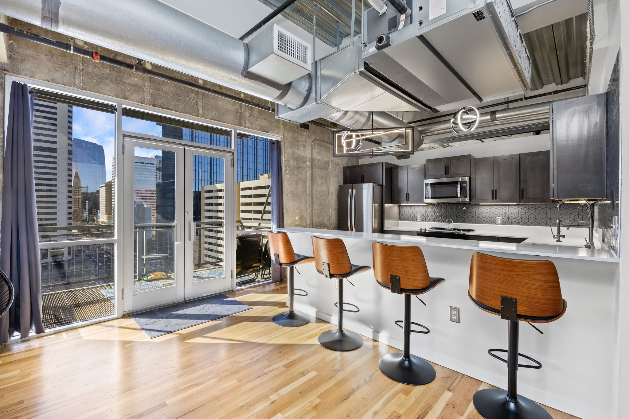This fully furnished 1 bedroom, 1.5 bathroom condo is located in the sought-after Arapahoe SkyLofts, right in the heart of Denver. Offering 1,124 square feet of thoughtfully designed living space, this home blends modern loft-style character with comfort and convenience.
 
The condo features hardwood floors, concrete walls, and exposed ductwork, creating a clean, contemporary industrial aesthetic. The open living area flows seamlessly into the dining space, which includes seating for four, plus two bar stools at the kitchen counter, making it ideal for entertaining or casual meals.
 
The spacious primary bedroom is furnished with a king bed and provides a quiet retreat. The primary bathroom includes a tub/shower combination, while a convenient half-bath powder room is located off the main living area—perfect for guests. An in-unit washer and dryer adds everyday convenience.
 
Step out onto the private balcony and enjoy views of downtown Denver, a perfect spot for morning coffee or evening relaxation.
 
Parking is a rare downtown luxury, and this unit includes two parking spaces in the attached garage—one suitable for a compact vehicle and the other for a full-size car.
 
Built in 1983, Arapahoe SkyLofts is ideally situated near Union Station and Coors Field, with easy access to downtown office buildings, public transportation, and major roadways. The neighborhood offers an abundance of restaurants, coffee shops, and retail options, all within close proximity.
 
This fully furnished condo provides an exceptional opportunity to enjoy urban living with space, style, and convenience in one of Denver’s most vibrant locations.