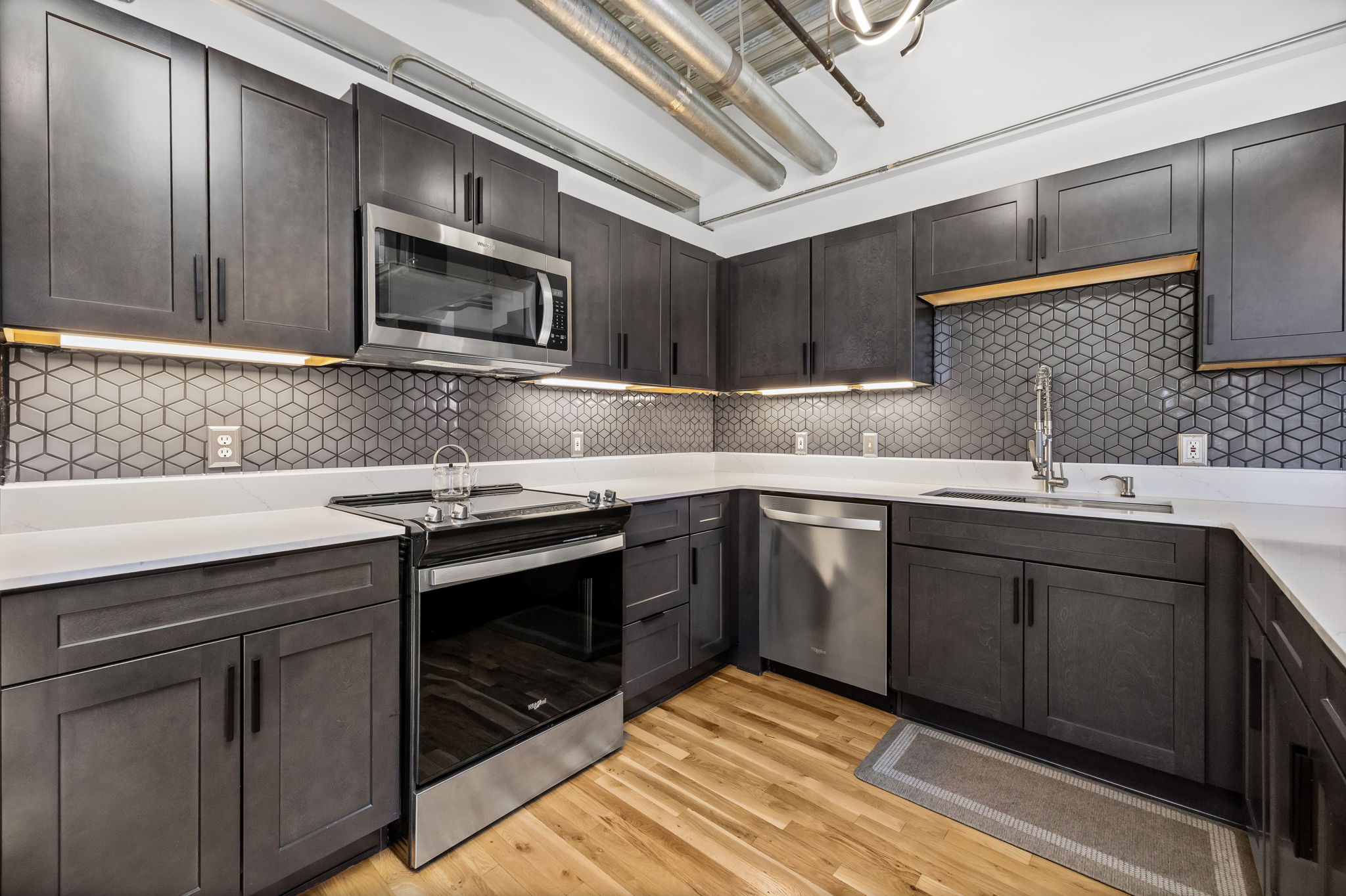 This fully furnished 1 bedroom, 1.5 bathroom condo is located in the sought-after Arapahoe SkyLofts, right in the heart of Denver. Offering 1,124 square feet of thoughtfully designed living space, this home blends modern loft-style character with comfort and convenience.
 
The condo features hardwood floors, concrete walls, and exposed ductwork, creating a clean, contemporary industrial aesthetic. The open living area flows seamlessly into the dining space, which includes seating for four, plus two bar stools at the kitchen counter, making it ideal for entertaining or casual meals.
 
The spacious primary bedroom is furnished with a king bed and provides a quiet retreat. The primary bathroom includes a tub/shower combination, while a convenient half-bath powder room is located off the main living area—perfect for guests. An in-unit washer and dryer adds everyday convenience.
 
Step out onto the private balcony and enjoy views of downtown Denver, a perfect spot for morning coffee or evening relaxation.
 
Parking is a rare downtown luxury, and this unit includes two parking spaces in the attached garage—one suitable for a compact vehicle and the other for a full-size car.
 
Built in 1983, Arapahoe SkyLofts is ideally situated near Union Station and Coors Field, with easy access to downtown office buildings, public transportation, and major roadways. The neighborhood offers an abundance of restaurants, coffee shops, and retail options, all within close proximity.
 
This fully furnished condo provides an exceptional opportunity to enjoy urban living with space, style, and convenience in one of Denver’s most vibrant locations.